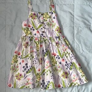 Girls spring dress! Has a cute back cutout with a bow. Size 5T.